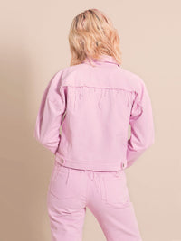 Backshot of a light pink upcycled jacket with frayed elements
