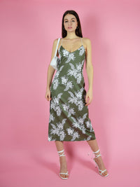 Frontshot of blonde gone rogue's green midi slip dress with thin, adjustable shoulder straps.