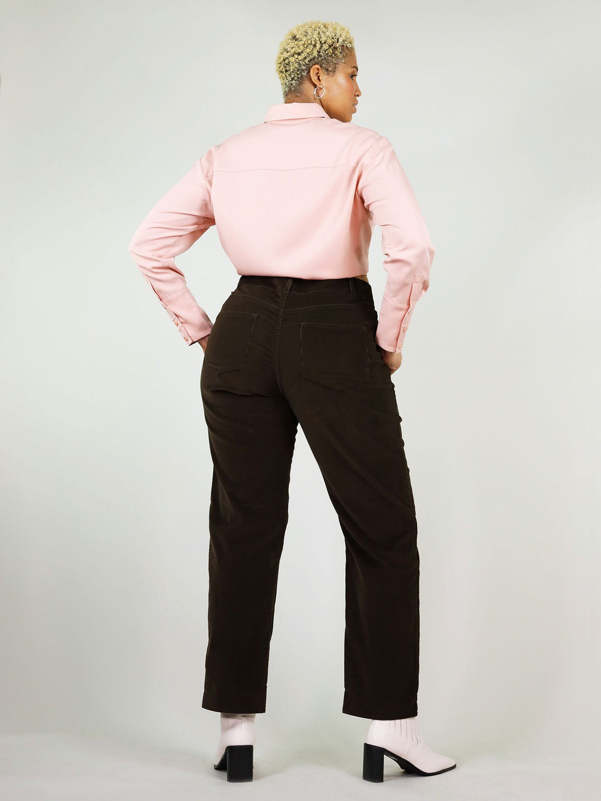 This is a backshot of the blushing pink summer shirt. It has comfortable fit around the shoulder, buttons down the arms and wrist, perfect to be tucked in.