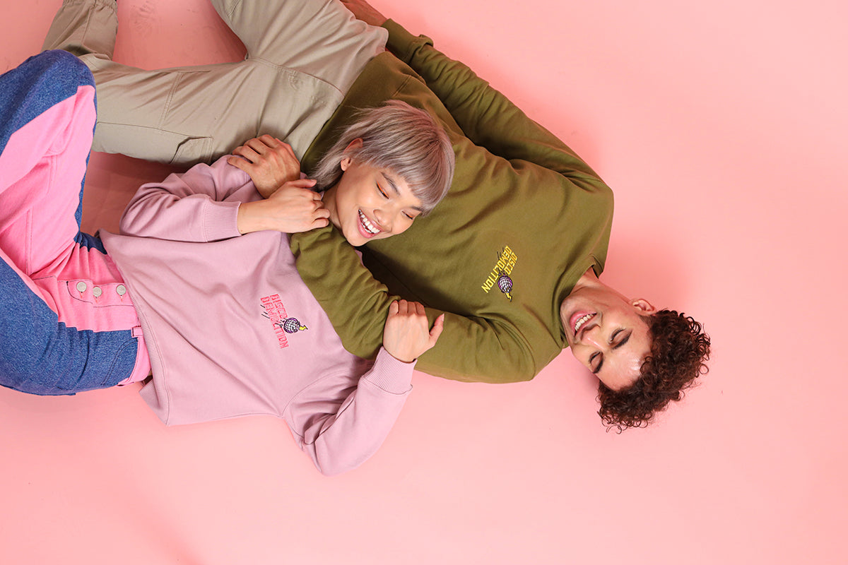woman and man wearing blonde gone rogue embroidered sweatshirts and hugging