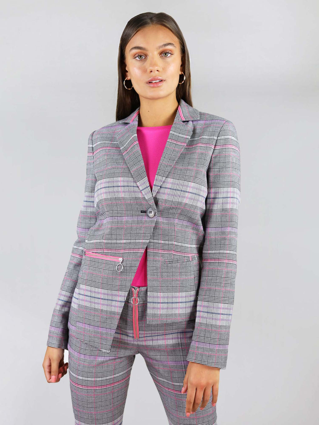 Rrvivify blazer in size XS. It is made out of different colours, mainly pink and grey. It has boxy fit and asymmetric shape that can be buttoned. 