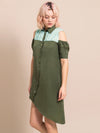 Blond woman wearing a sustainable, cold-shoulder, above-the-knee, assymtric dress in military green with light blue details around the shoulders