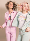 Two happy girls in a pink and blue denim jackets and white t-shirts