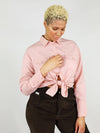 Close-up shot of the blushing pink, summer shirt. It has comfortable fit, two front large pockets, buttoned down and can be tied up in the middle for a sexier look. 
