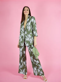Frontshot of the girlboss trouser suit by blonde gone rogue. The pant suit is green with white floral print.