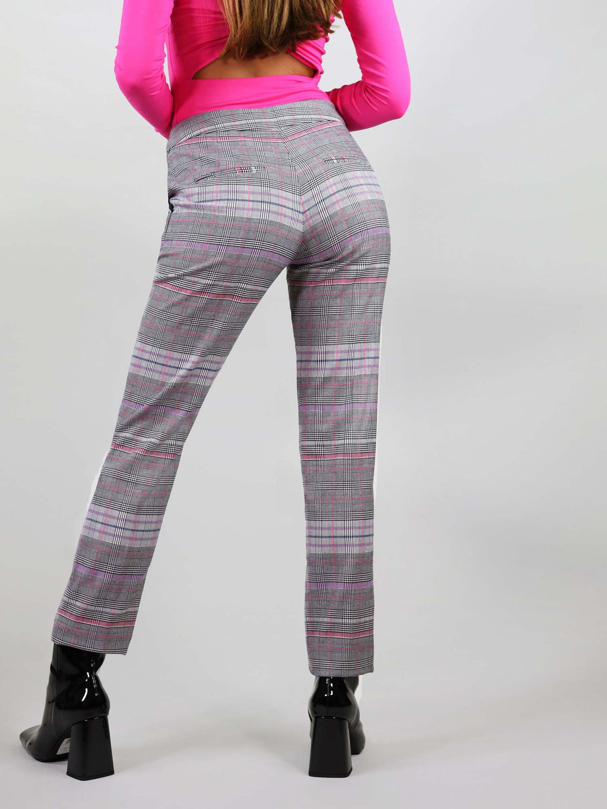 Back view of the revivify trousers in pink a grey checker fabric. It has bright pink details and slim fit, comfortable wear.