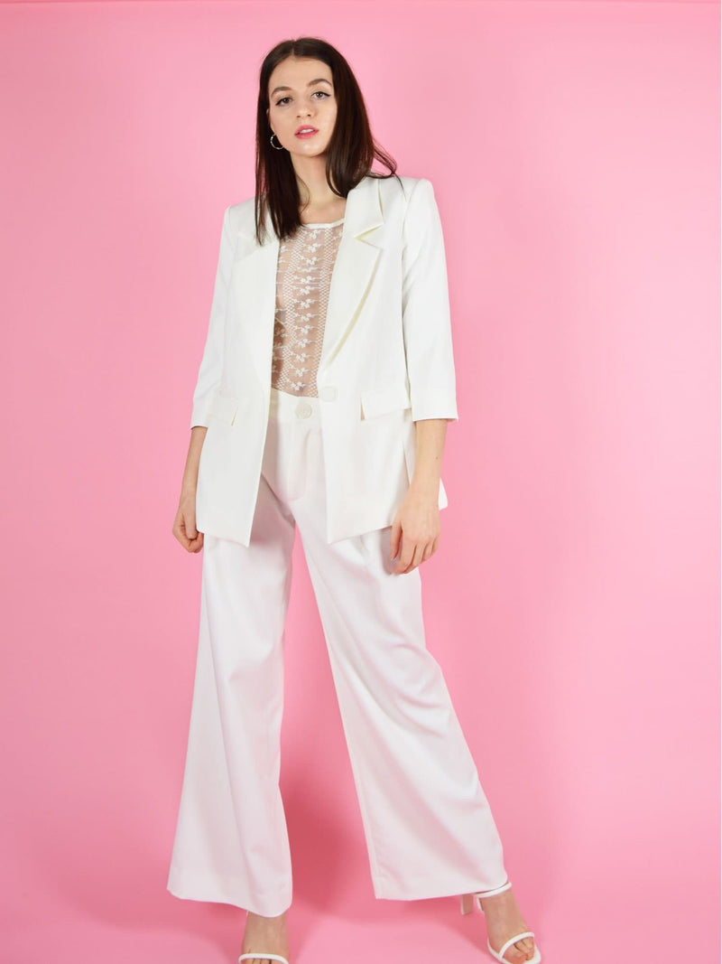 Frontshot of blonde gone rogue's girlboss trouser suit. The pant suit is elegant and perfect for wedding guests.