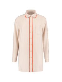 Beige, oversized shirt with yellow piping around the buttons