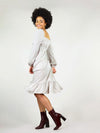 Pleated bottom and calf’s length. Elastic at the cuffs and under bust. Long sleeve and backless square design. 