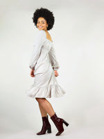 Pleated bottom and calf’s length. Elastic at the cuffs and under bust. Long sleeve and backless square design. 