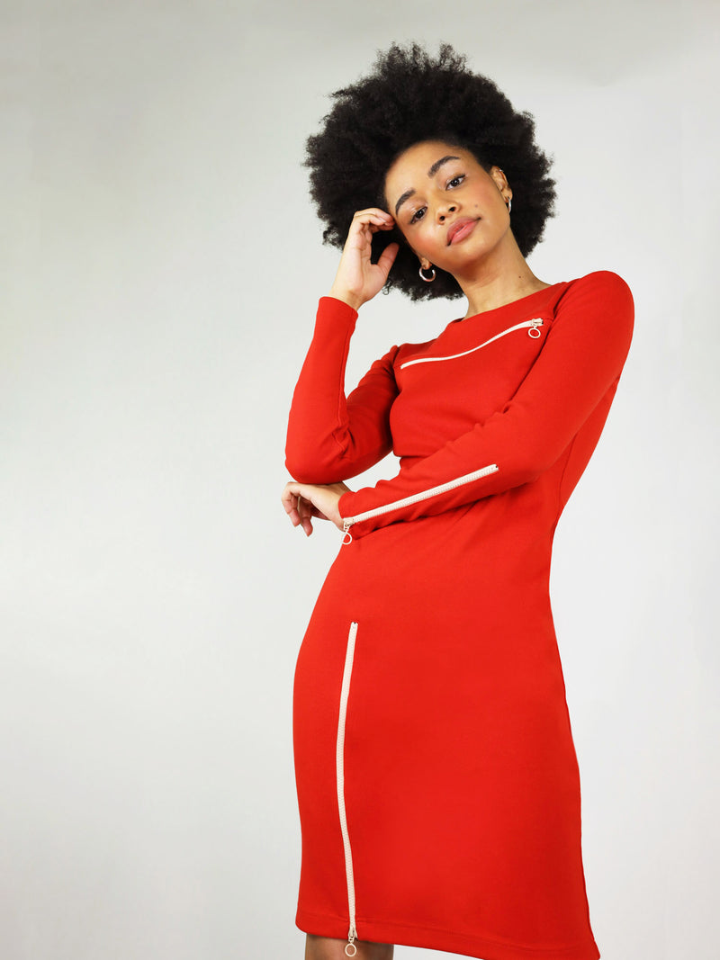 Round neck, long sleeves and white zips, the wicked zipper dress in red is a perfect addition to your wardbrobe. One zip is located on the left arm, one under the collar bone area and last one on the right leg. 