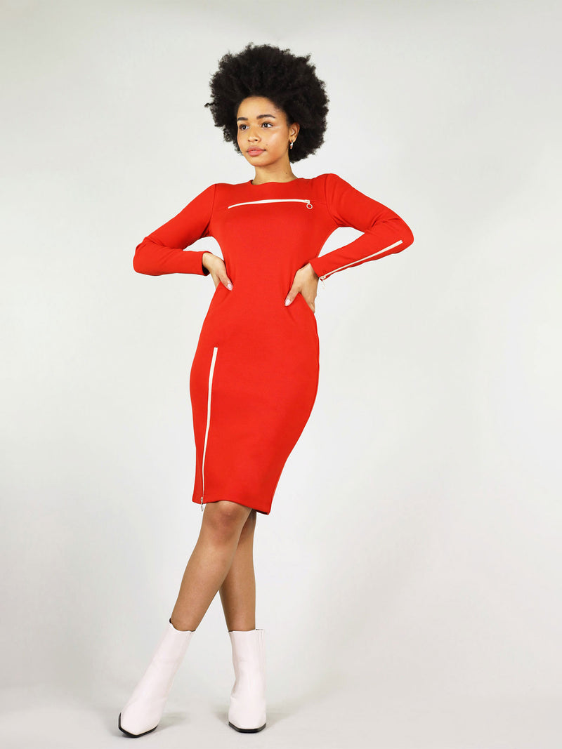 The red wicked zipper dress has round neck and a white zipper under the collar bone area. Under knee length with white zip on the right leg side and long sleeves. 