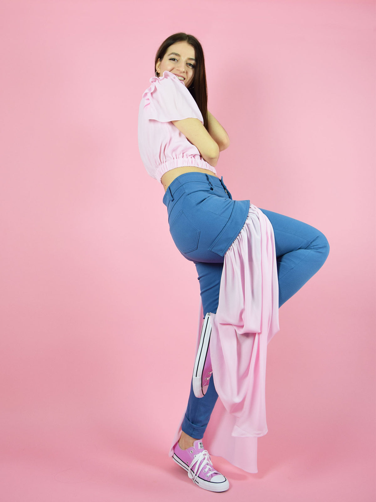 sideshot of the wildflower skinny high-waisted jeans with detachable pink veil and the wildflower sustainable surplice crop top in pink by blonde gone rogue